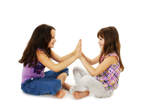 two girls play pat a cake